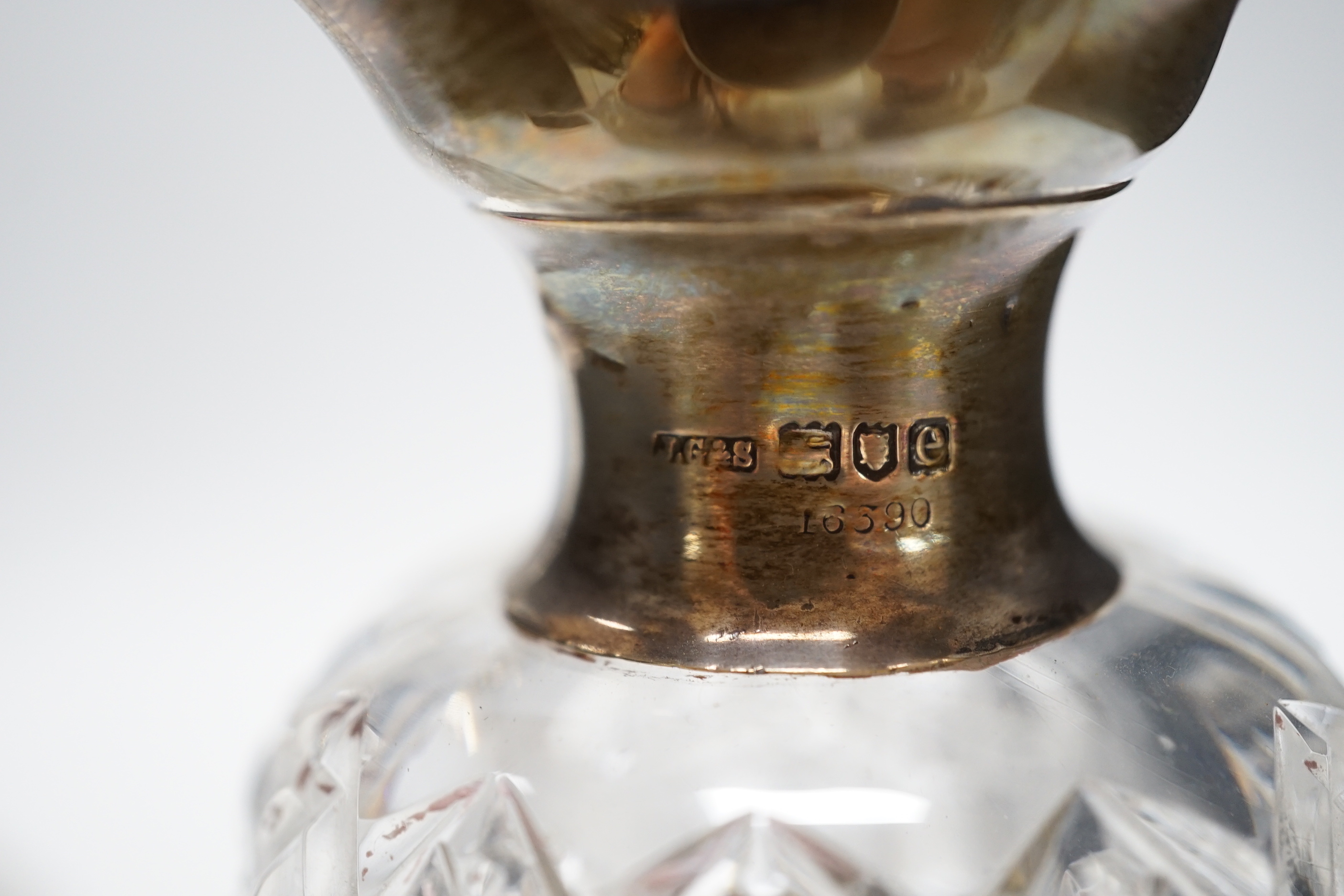 A pair of late Victorian silver mounted cut glass waisted tri-lipped decanters, with stoppers, John Grinsell & Sons, London, 1900, 28.5cm.